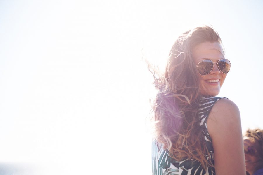 Tamra Hill in Malibu, California with windblown hair and ray ban sunglasses