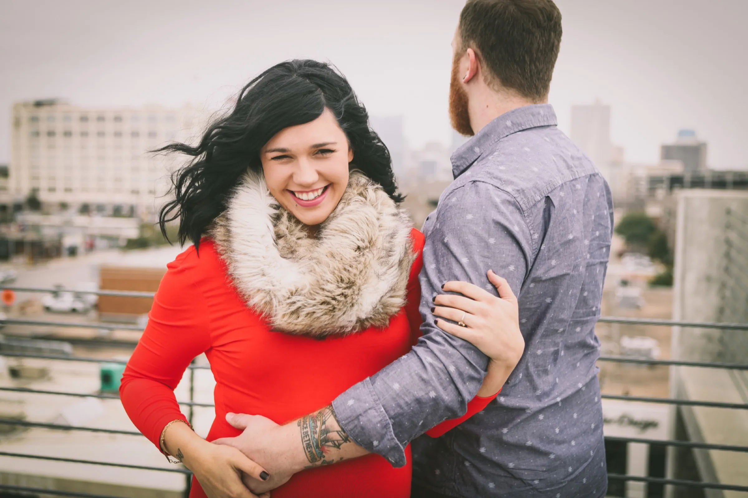Jaymes and Jordan Downer maternity photoshoot in downtown fort worth red dress with fur scarf