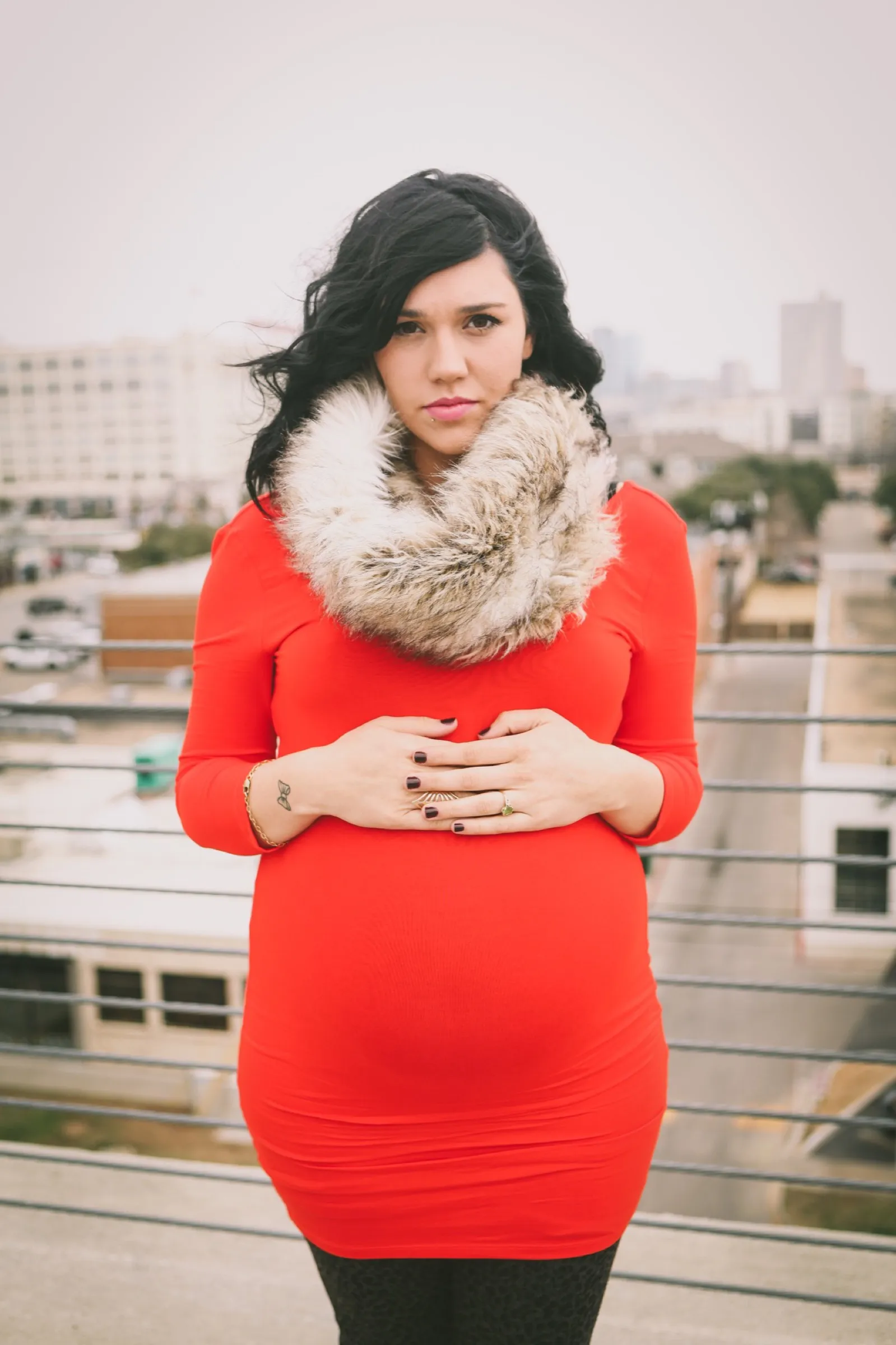 Jordan Downer maternity photoshoot in downtown fort worth red dress with fur scarf