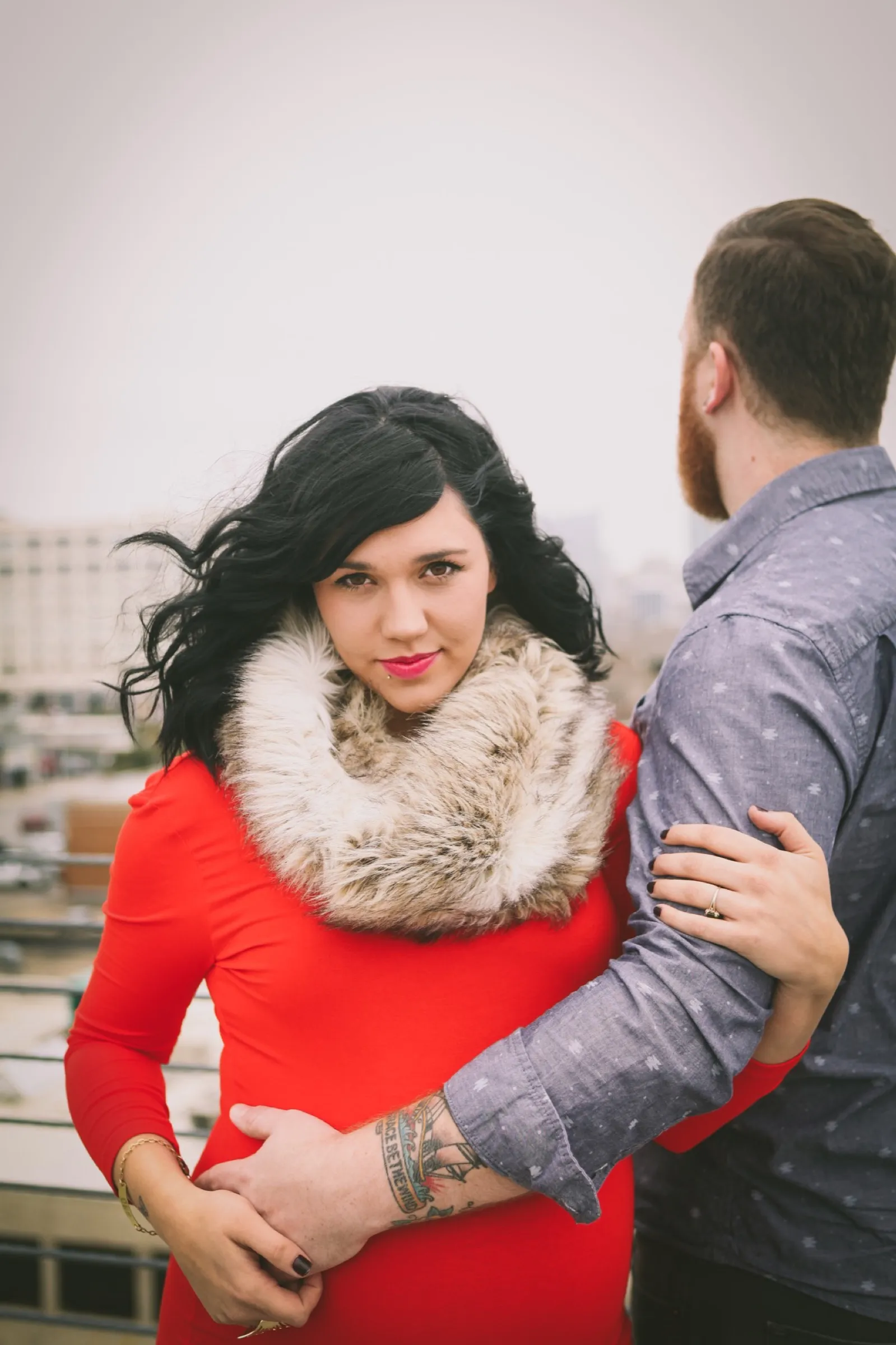 Jaymes and Jordan Downer maternity photoshoot in downtown fort worth red dress with fur scarf